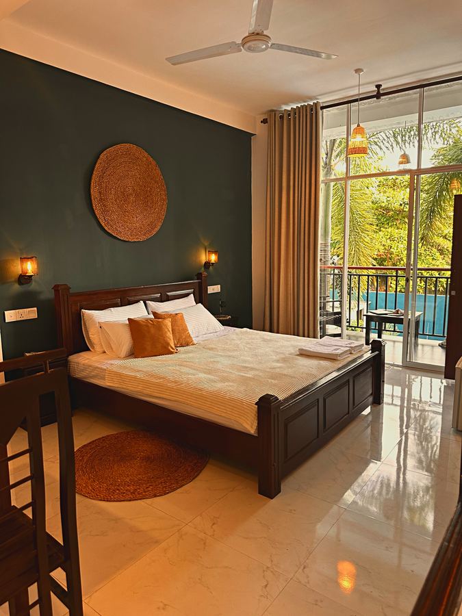 Pool View Double — king bed, balcony doors open to the pool